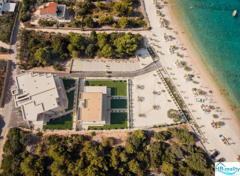 Aerial view of a holiday apartment in Sevid near a beautiful beach and crystal-clear sea.