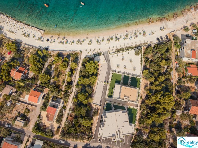 Aerial view of the sandy beach and surrounding nature at the Sevid Holiday Apartment.