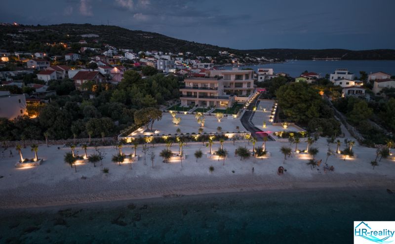 Night view of the Recreational Apartment in Sevid with illuminated beach and surrounding landscape.