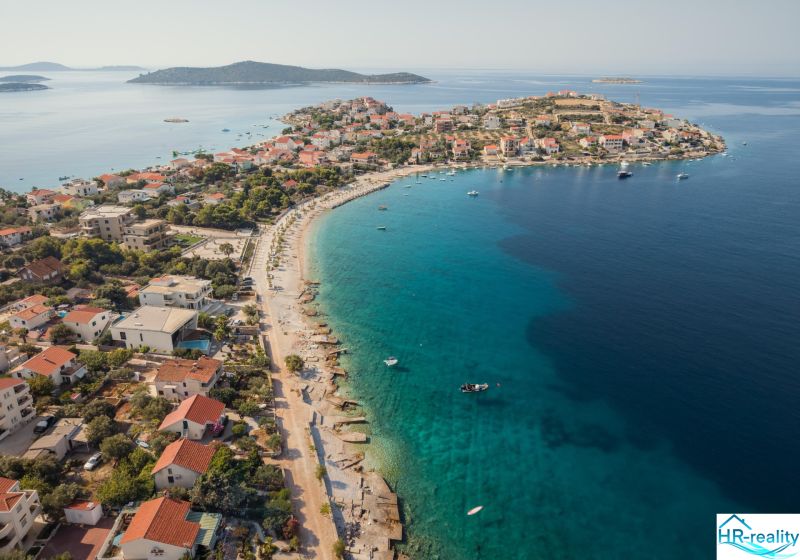The coast of Sevid with recreational apartments and azure sea in a summer atmosphere.