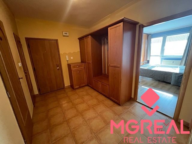 Entrance hall with tiles, built-in wardrobe, and a view into a 3-room apartment.