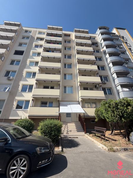 The exterior of the apartment building on Palkovičova Street in Topoľčany with parking in front of the 3-room apartment.