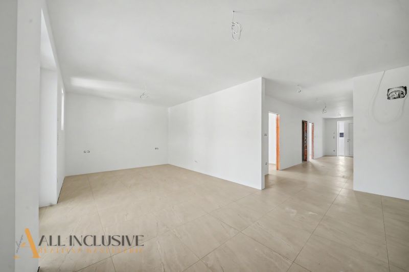 The interior of a family house with a ceramic floor and white walls ready for completion.