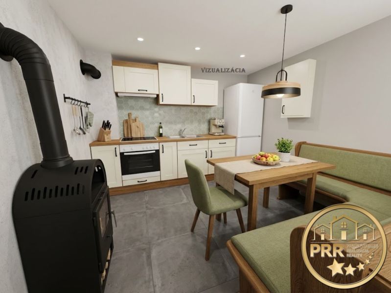 A kitchen in a cabin with a fireplace, a dining table, and green upholstered seating.