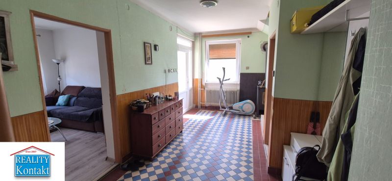 Interior of a family house with a hallway, a dresser, and an exercise machine.