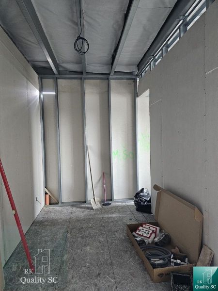 Unfinished interior of a family house with a toolbox and metal frames.
