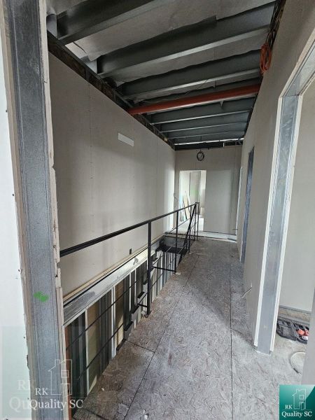 Construction work inside a family house with a staircase and incomplete walls.