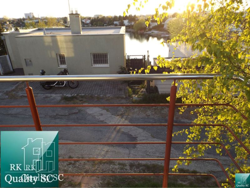 View of the water and roof from the balcony of a family house at Sunny Lakes South, Senec.