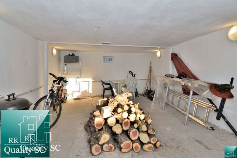 A garage in a family house with wood, a bicycle, and tools.