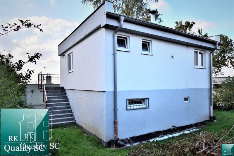 Cottage at the SUNNY LAKES SOUTH in Senec with stairs and a white facade.