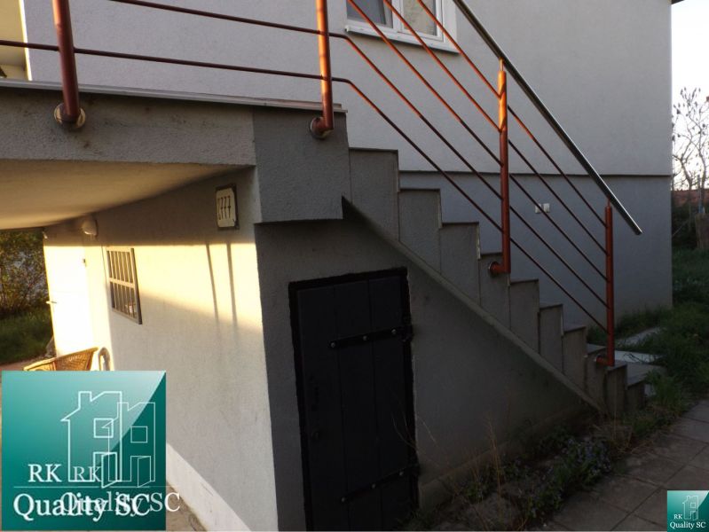Exterior of a family house at Sunny Lakes South in Senec with a staircase and railing.