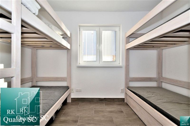 A simple room with bunk beds and a window, Cottage.