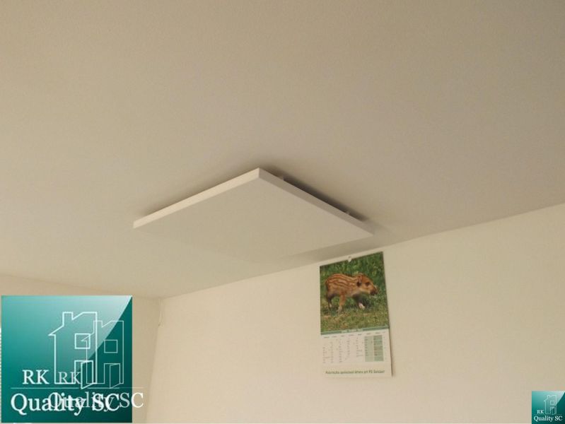 White ceiling with an infrared panel and a calendar in the Cottage.