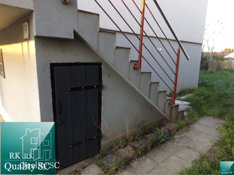 Entrance to the cottage at SUNNY LAKES SOUTH in Senec, stairs with a red railing.