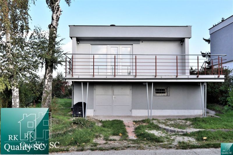 Cottage at the SUNNY LAKES SOUTH in Senec with a green lawn and an outdoor staircase.