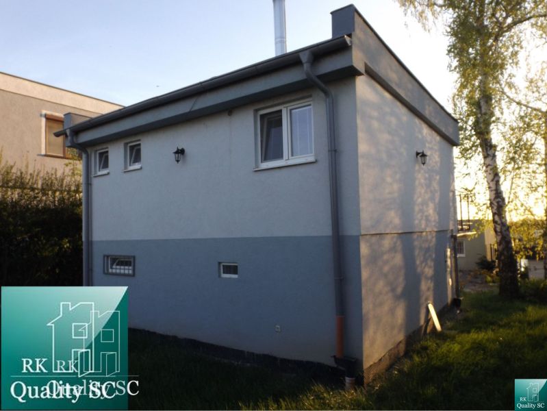 Cottage at SUNNY LAKES SOUTH in Senec, surrounded by grassland and trees.
