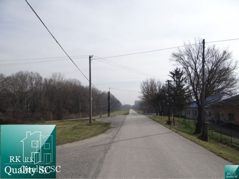 Road at the Old Port Gabčíkovo for Land - housing, surrounded by trees.