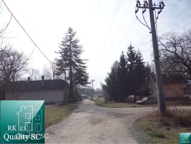 The country road to the Old Gabčíkovo Port surrounded by houses and trees, Residential plots.