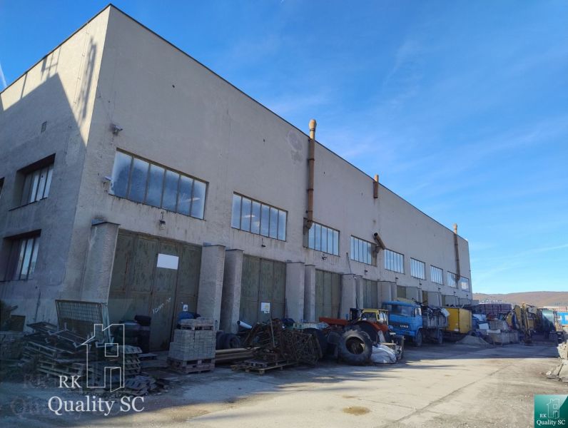 Warehouses and halls on Staviteľská Street in Bratislava III with trucks and materials.