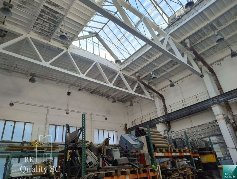 Interiors of warehouses and halls with large windows, storage shelves, and industrial lighting.