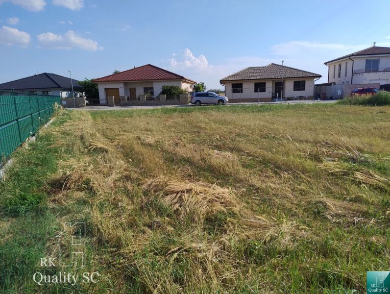 Plots - housing in Senec, grassy area with a view of family houses.