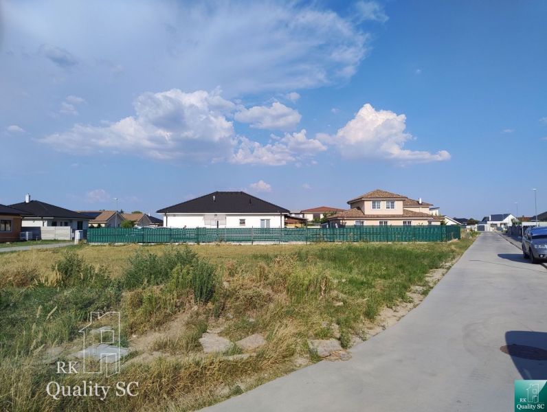 Residential plots in Senec with a view of family houses and the sky.