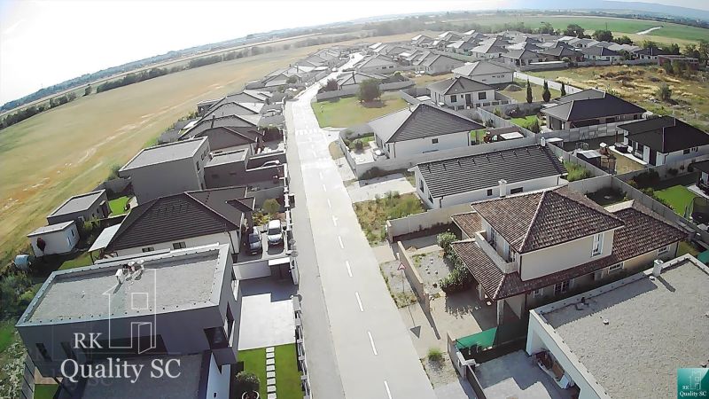 Aerial view of a residential district and surrounding housing plots in Senec.
