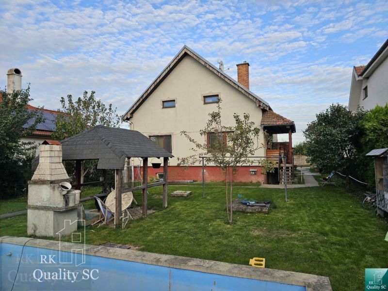 A family house on Tureň Street in the village of Tureň with a lawn and a gazebo.
