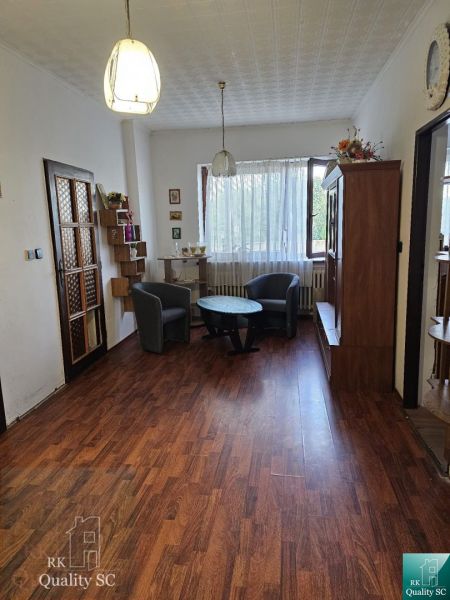 Living room in a family house with a wooden decor floor and comfortable furniture.
