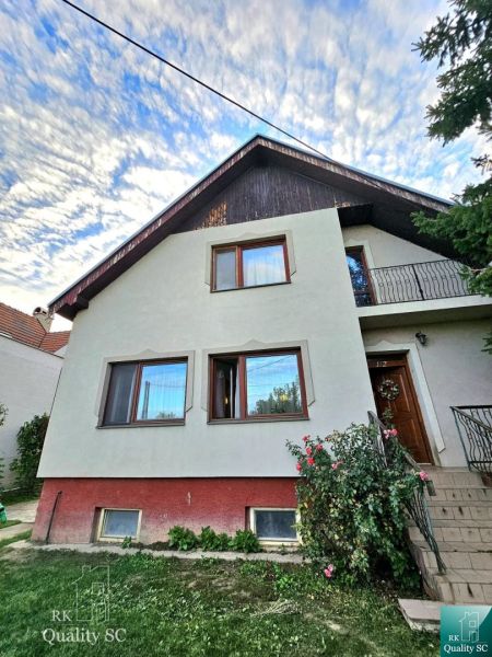 A family house in the town of Tureň on Tureň Street with a colorful facade and a garden.