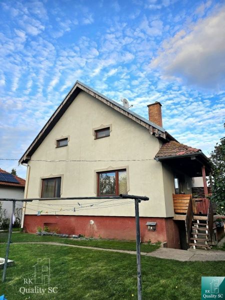 Family house in Tureň on Tureň street with a lawn and a clothesline.