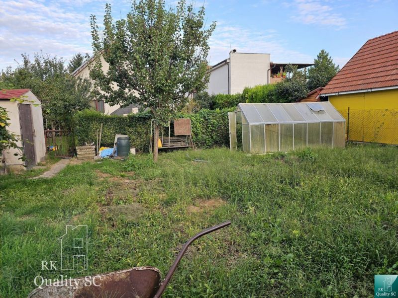 Garden of a family house in Tureň with a cottage and a greenhouse on Tureň Street.