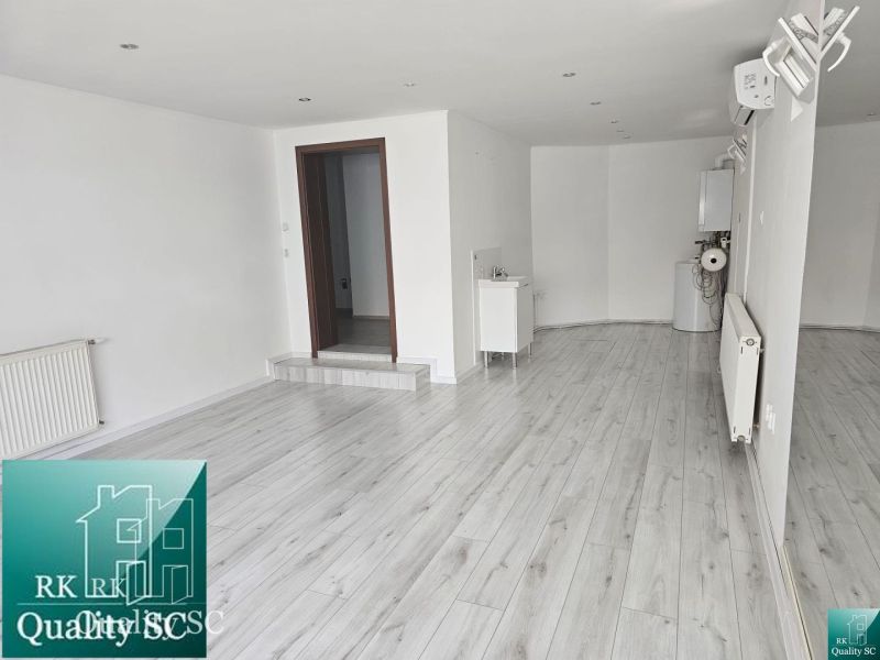 Interior with wood-patterned flooring and air conditioning in commercial premises.