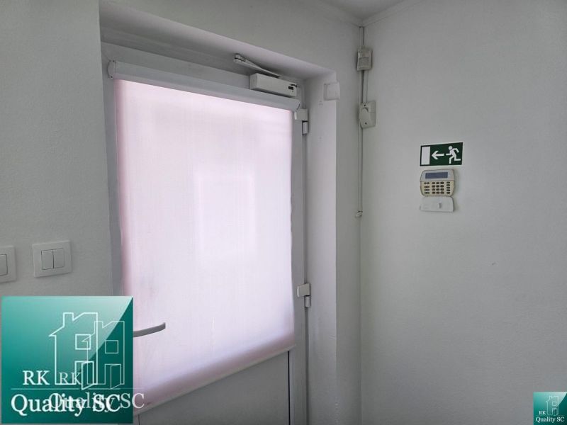 White doors with a shutter and an emergency exit in commercial premises.