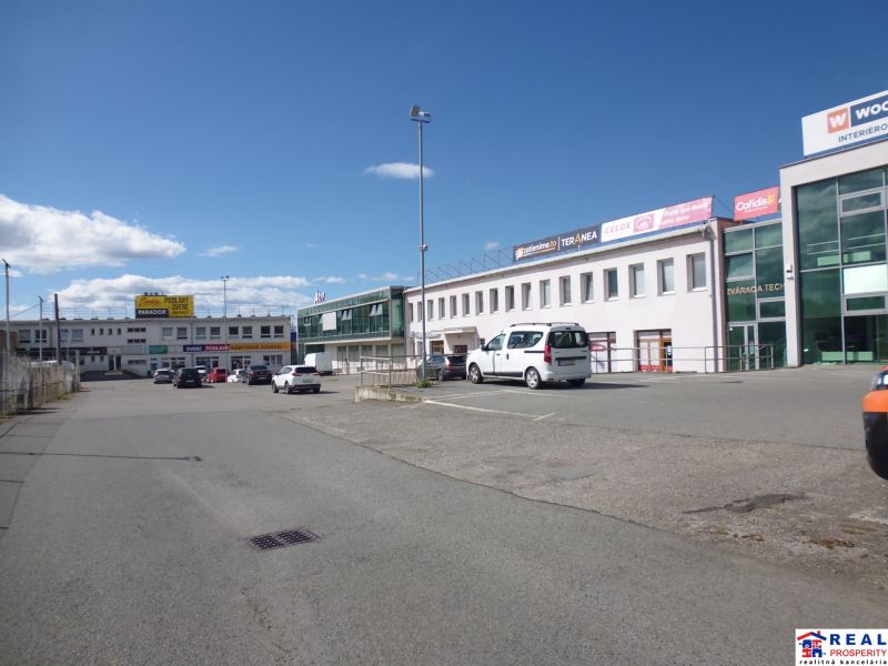 Commercial premises on Strojnícka Street in Prešov with parking and retail units.
