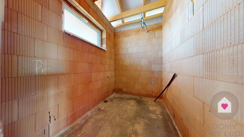An unfinished room with brick walls in a family house, ready for further renovation.