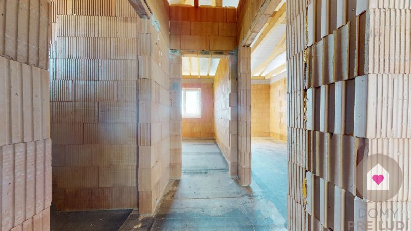 Construction of a family house with brick walls and a concrete floor.