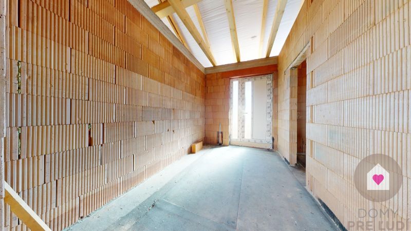 A building in a family house with a view of bricks and raw concrete.