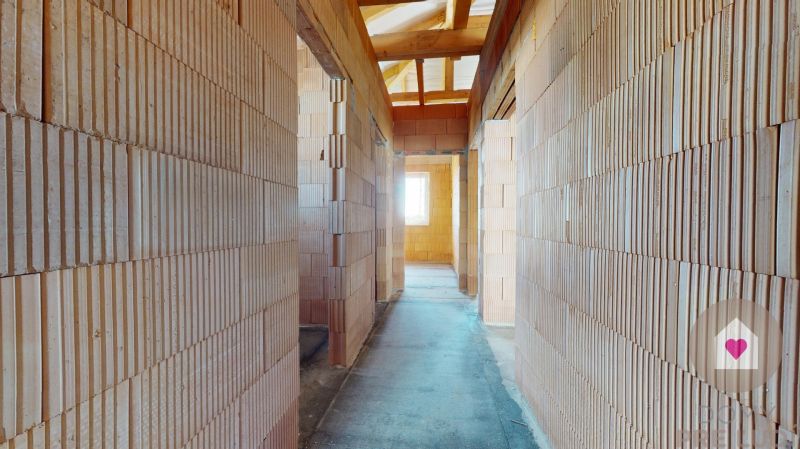 A brick interior hallway under construction, without plaster, Family house.
