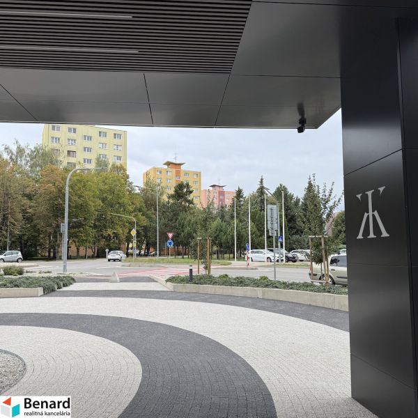 The view from Karpatská Street in Poprad features colorful apartment buildings and greenery.