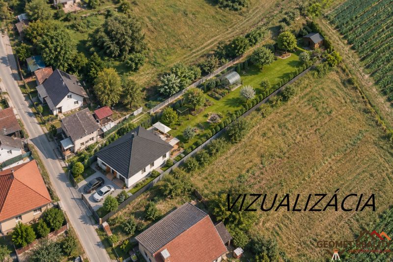 Aerial view of family houses in Mikušovce surrounded by greenery and gardens.