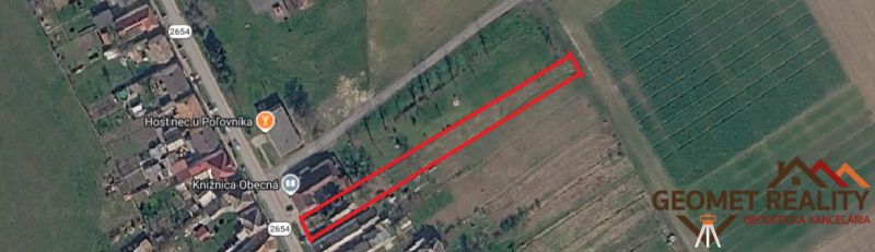 Aerial photograph of the land in Mikušovce, next to the main road and buildings.