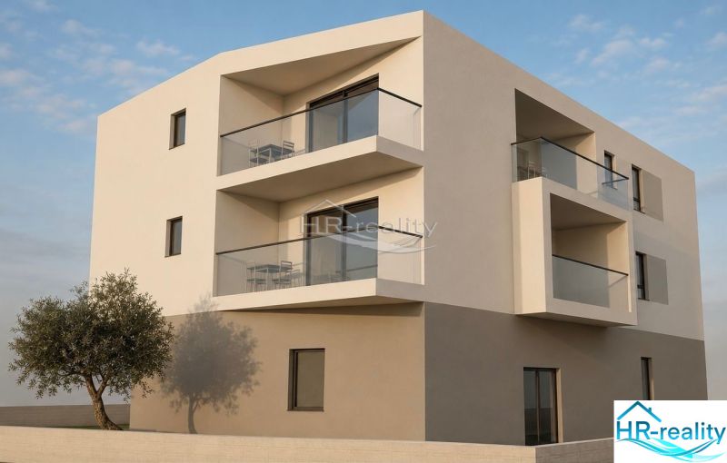 The exterior of the building of the Recreational Apartment in the city of Vodice with modern balconies and a tree.