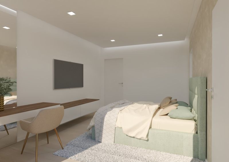 A bedroom in a 4-room apartment with a TV, a desk, and a bed.