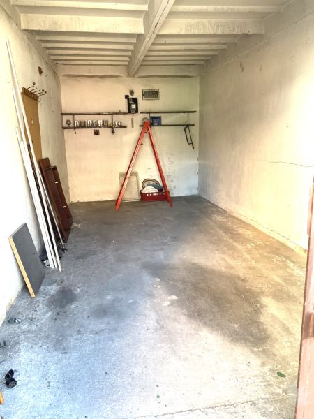 In the garage on Čmelíkova Street in Bratislava - Ružinov, there are stairs and a simple shelf.