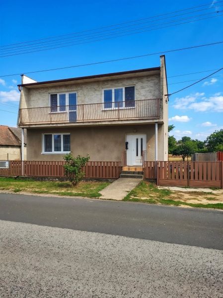A family house in Záhorská Ves with a garden and a balcony on the upper floor.