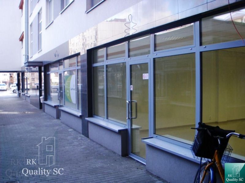 Glass-walled offices on Lichnerova Street in Senec with a parked bicycle.