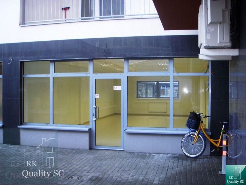 The glass facade of the office on Lichnerova Street in Senec with a bicycle parked outside.