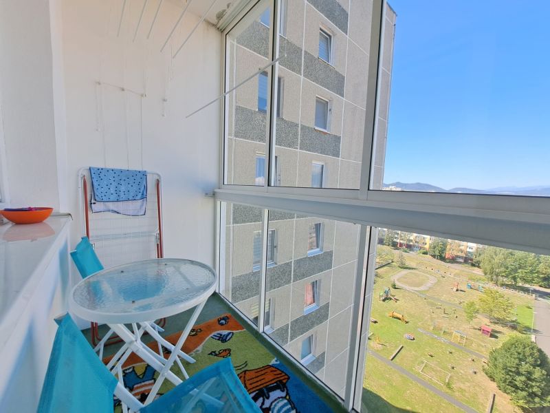 Glazed balcony of a 3-room apartment on Jesenná Street in Poprad with a view of the courtyard.