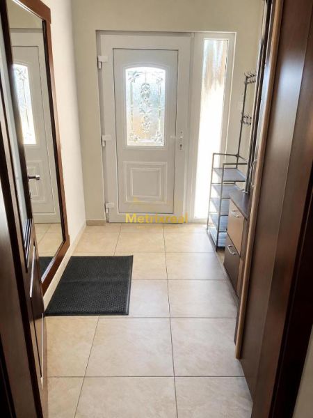 Entrance hall with tiles and white doors in a family house.
